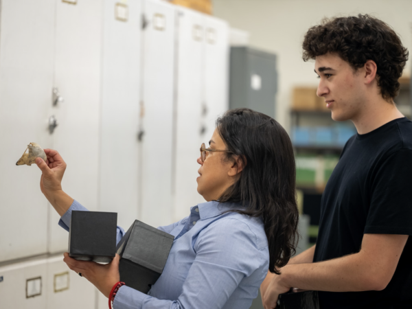 Dr. Glau Del-Rio studying an owl specimem with student Thomas Lilkendey